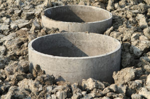 two concrete pipes coming from underground