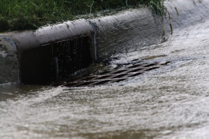 Water rushing down storm sewer after heavy rain fall