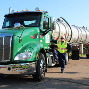 Man Standing Next to his Truck