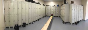 room filled with lockers and boots on the floor and on top of the lockers